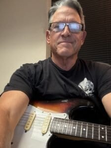 Tom Bacon playing guitar
